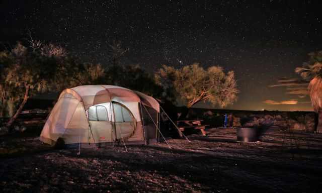 Tent under the night sky in the desert