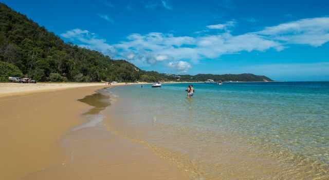 One of the many breathtaking beaches with view visitors and turquois water.