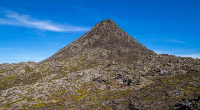 Climbing hikers on the Lava Cone of Pico on a sunny day.