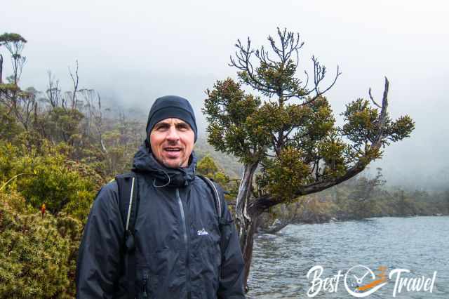 A hiker with warm clothes and beanie at the lake