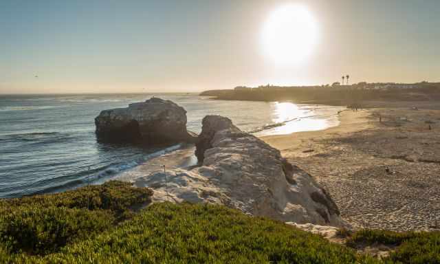 The view down to the Natural Bridges State Beach shortly before sunset.