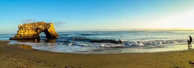 Natural Bridges State Beach people walking along and swimming.