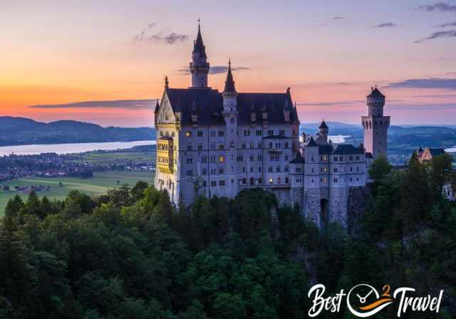 Neuschwanstein at sunset with switched on lights in the castle.