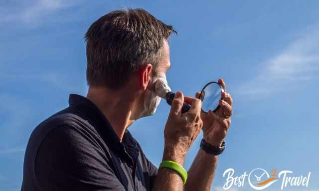 A man shaving the face with cream