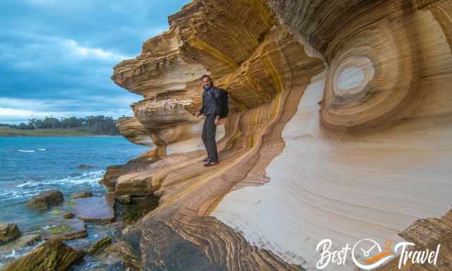 A visitor standing on the Painted Cliffs