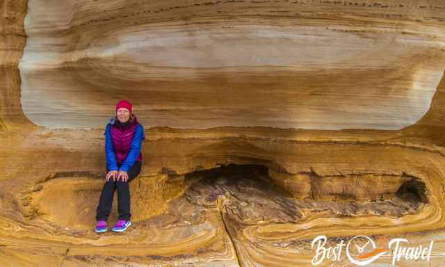 A woman sitting on a rock in the Painted Cliffs