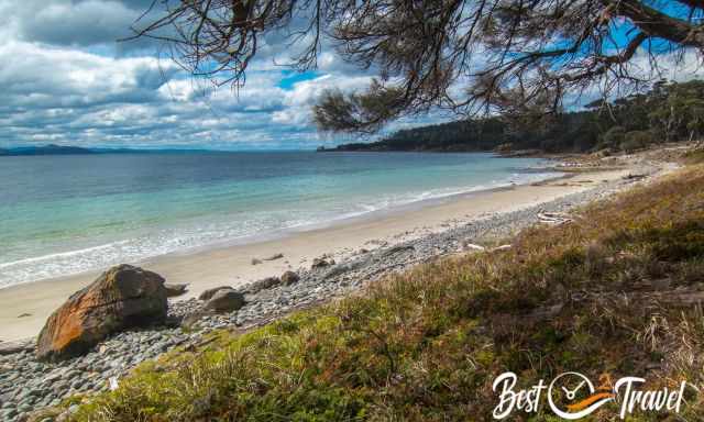 A white beach and the Emerald green and blue sea on Maria Island