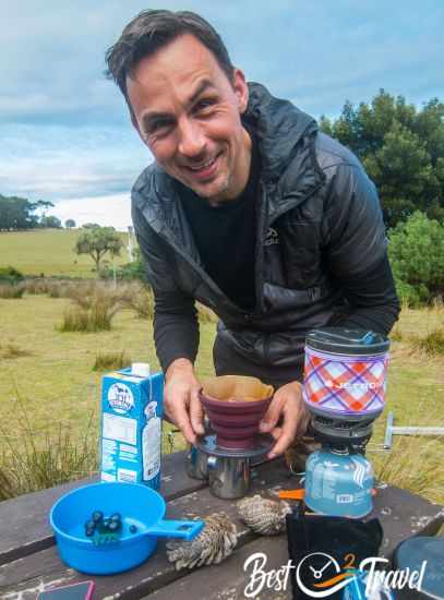 A camper is preparing coffee in the morning