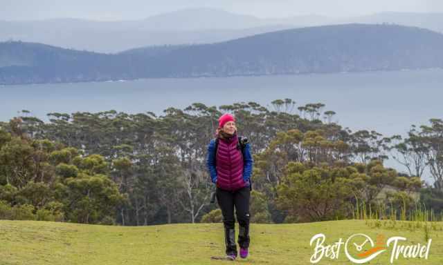A hiker woman on higher elevation with hills and 