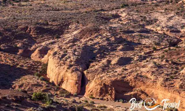 Peek-A-Boo entrance and entire slot canyon from higher elevation in the distance