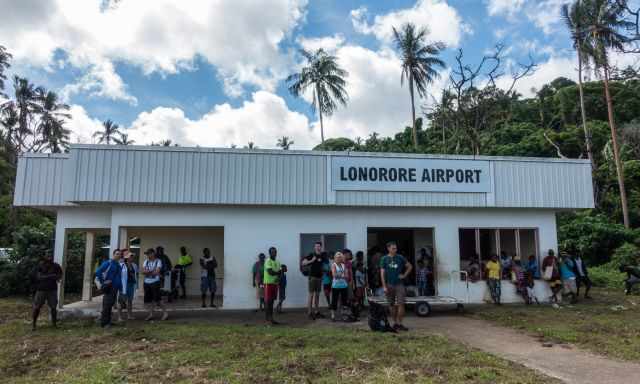 Lonorore aiport with people and guides waiting for shuttle departure.