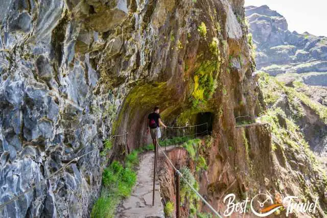 A hiker on the narrow and exposed track