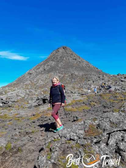 Hiker standing inside the Pico crater with the steep volcanic cone rising prominently in the background.