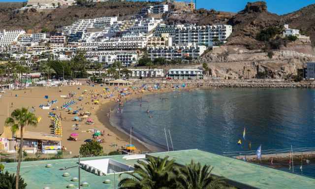 Playa de Puerto Rico with sunbathers and swimmers