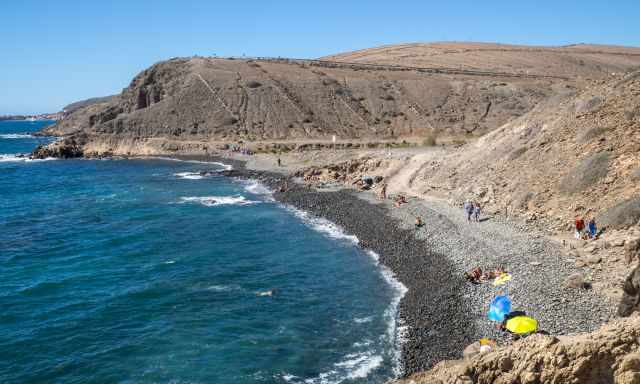 People are sunbathing and swimming at the beach of the carpenters