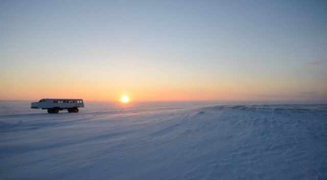 Viewing buggy on ice in the tundra during sunset