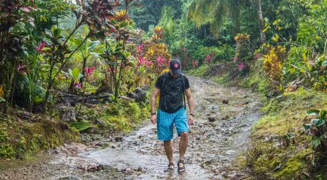 Man standing in heavy rain shower