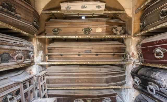 View to the inside of a mausoleum full of coffins