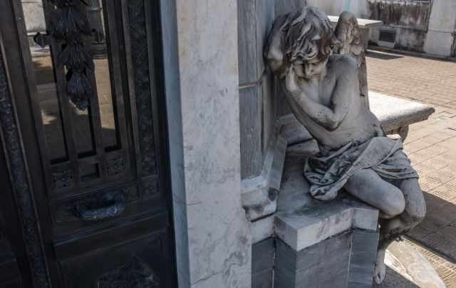 A marble angle at the entrance of a mausoleum