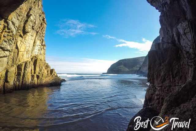 The waves got closer to the cave because of the rising tide.