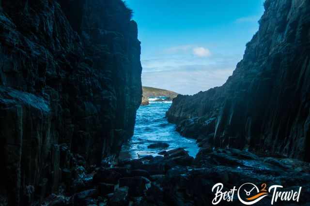 View out of the cave to the sea and the incoming tide.