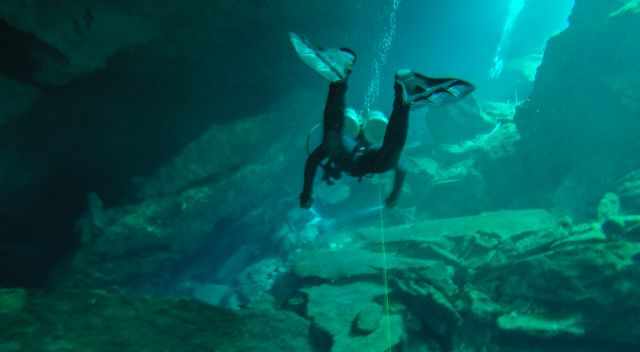 Diver in a cenote following the line only