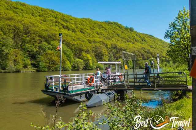 A ferry on river Saar with hikers and bikers.