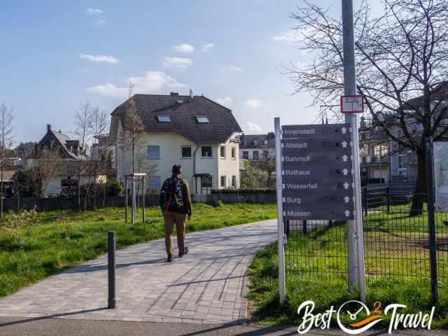 A visitor following a sign in Saarburg to the waterfall