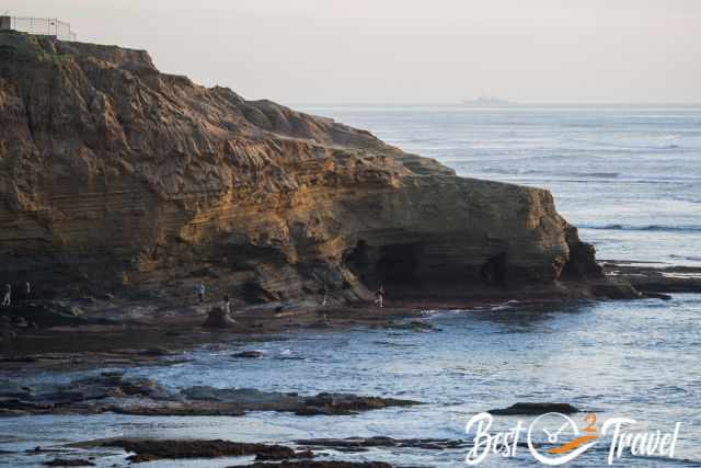 People walk into some the Sunset Caves at Sunset Cliffs