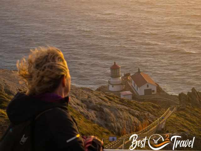 A woman looking to the Point Reyes lighthouse.