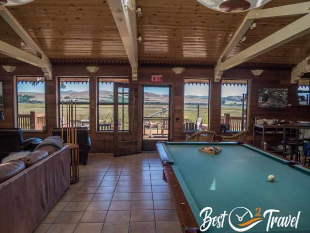 A lodge room with billiard and kitchenette.