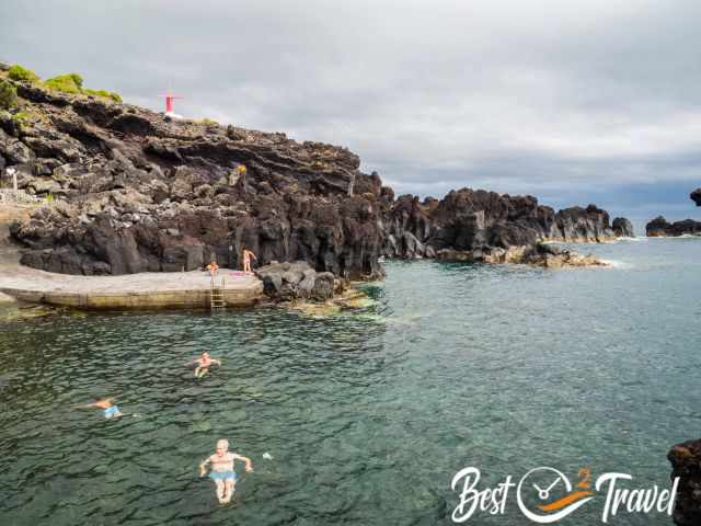 Swimmers enjoying the refreshing sea in the sheltered bay of Urzelina 