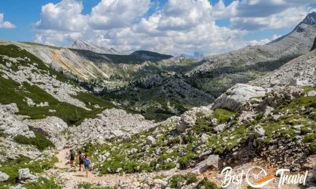 Hikers on the rocky path with the Tree Cime de Lavaredo in the back