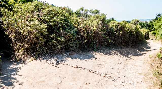 An arrow made with pebbles marks the shortcut