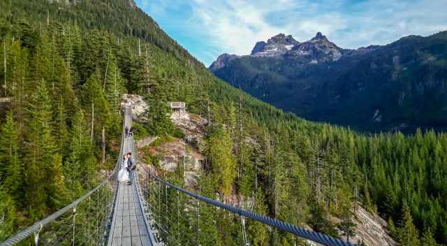 Standing on the suspension bridge with view to Sky Pilot and Ledge Mountain.