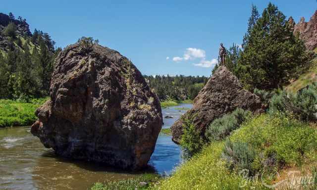 A man on a huge rock in the Crooked River