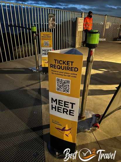 The fenced penguin pier and a sign indicating a ticket is neccessary.