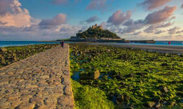 The Mount at low tide with a few people on the causeway.