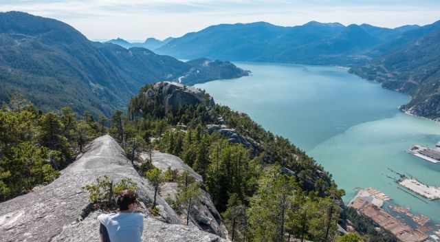 A hikers enjoys the spectacular view from the second peak.