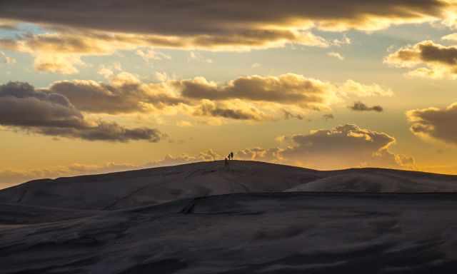 Three people on the top of the Maspalomas Dunes