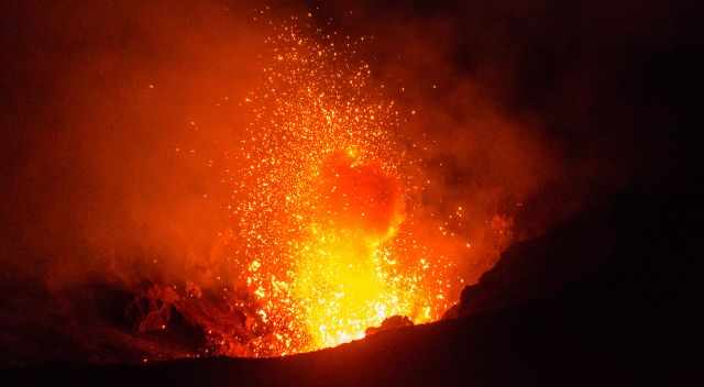 Erupting Yasur with fire and ash clouds