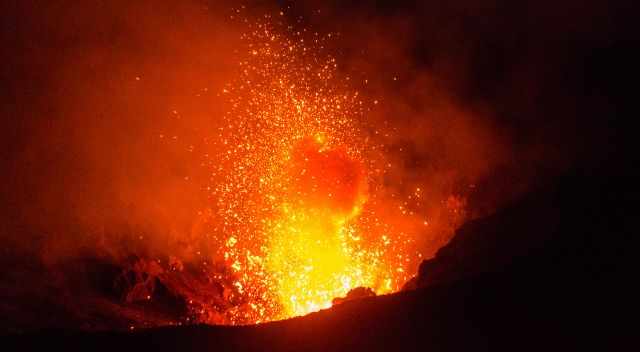 Erupting Yasur with fire and ash clouds