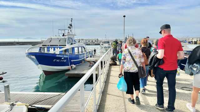 Guests access the whale watching boat.
