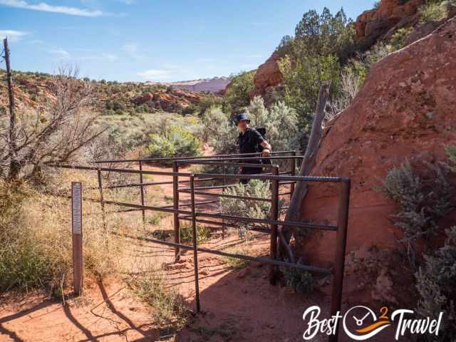 A hiker accessing the entrance gate to the Wave trail