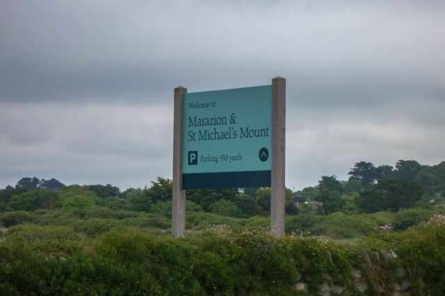 Welcome sign at the entrance to Marazion and St Michael’s Mount and pointing visitors toward the nearby parking area.