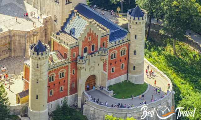 Neuschwanstein huge entrance door from high elevation with zoom camera.