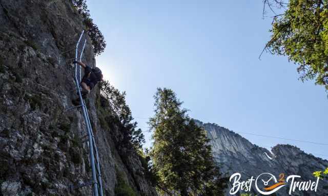 A climber on the red route - via ferrata on a long ladder.