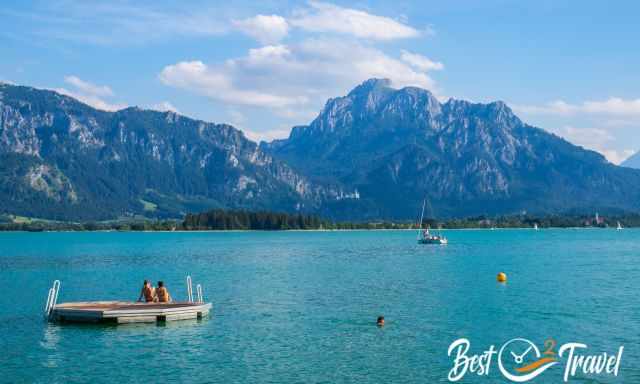 Swimmers and a boat on Lake Foggensee.