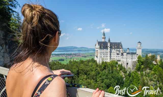 A woman on Marienbrücke looking to Neuschwanstein.