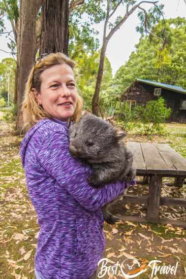 A woman holding a wombat.